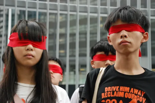 Demokratie-Aktivisten Agnes Chow und Joshua Wong am 23. September 2014. Die Demonstranten trugen rote Augenbinden als Symbol für die von Chinas politischer Macht geblendeten Studenten. / Wikimedia (CC0) 