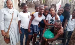 Ordensschwester der „Lauritas“ im Batey 5 besucht mit Jugendlichen einen hilfsbedürftigen Mann / Kirche in Not