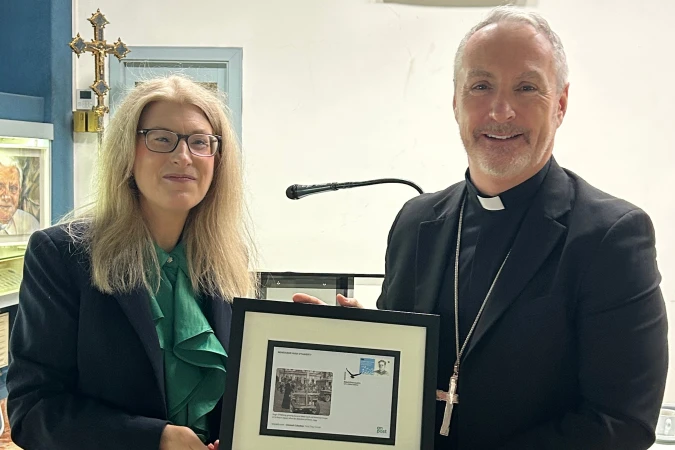 Übergabe des Erstbriefs der Sonderbriefmarke von Msgr. Hugh O’Flaherty: links Botschafterin Frances Collins, rechts Erzbischof John Joseph Kennedy